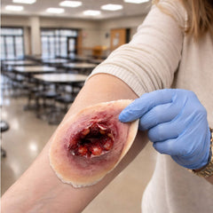 Peel-and-stick reusable gunshot wound moulage used in trauma training